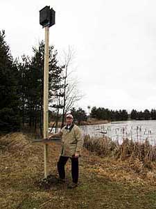 Photo of Steve Tennes with a new bat house.
